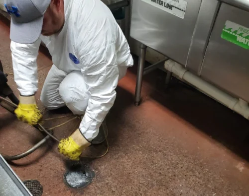 worker doing drain cleaning